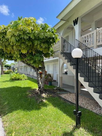 Side view of a two-story building with external staircases.