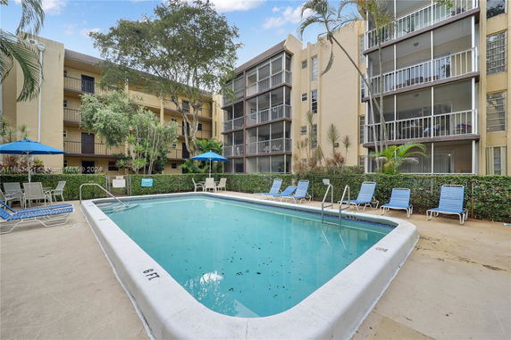 Outdoor swimming pool surrounded by apartment buildings.