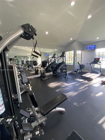 Indoor gym with fitness equipment including treadmills and exercise machines.