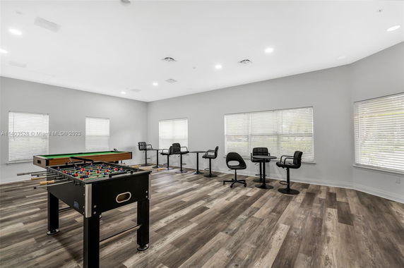 Room with foosball table and seating area.