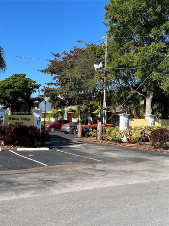 Outdoor parking area near a building entrance.