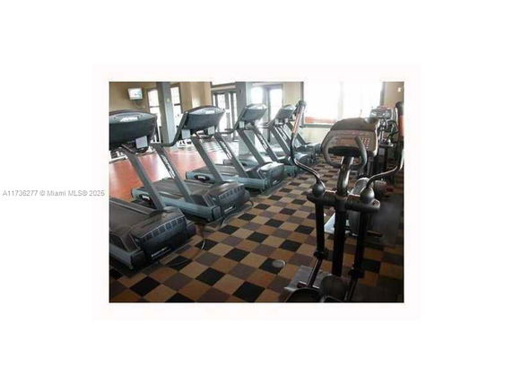 Indoor gym area with treadmills and exercise machines.