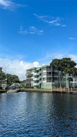 Front view of a multi-story residential building near the water.