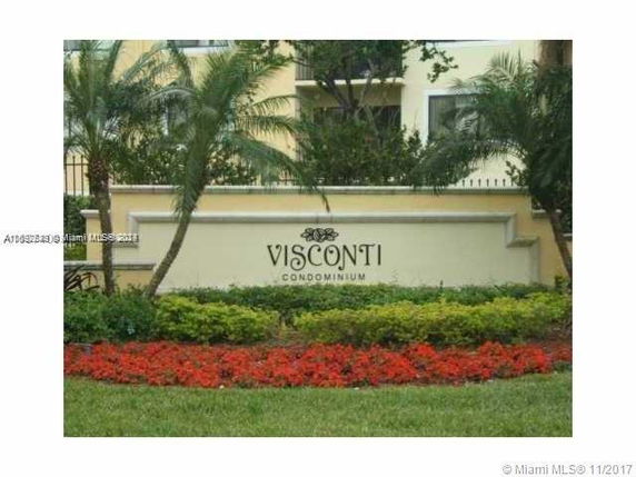 Front view of a building labeled Visconti Condominium, with landscaping.