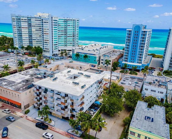 Aerial view of multiple buildings near the ocean with a clear sky.