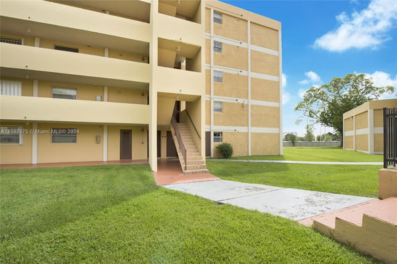 Front view of a multi-story building with staircases and balconies.