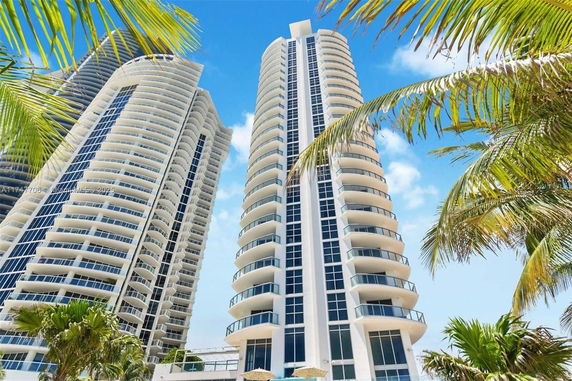 Front view of high-rise residential buildings with balconies and glass facades.