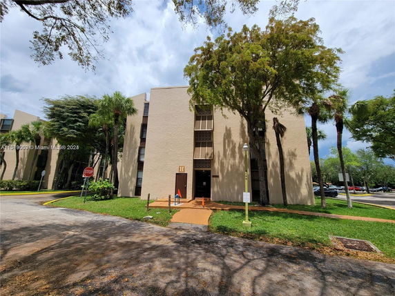 Front view of a multi-story residential building with beige exterior.