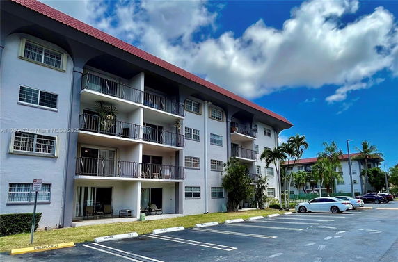 Front view of a multi-story residential building with balconies.