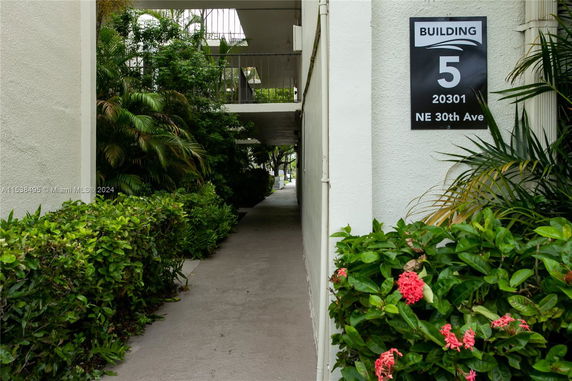 Entryway of a building labeled as Building 5, with surrounding greenery.