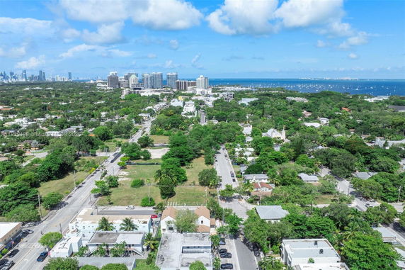 Panoramic view of a cityscape with buildings and water in the background.