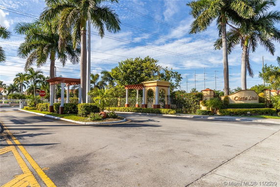 Entrance structure with columns and archway at a gated community.