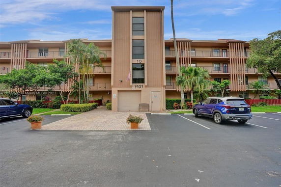 Front view of an apartment building with multiple floors and balconies.