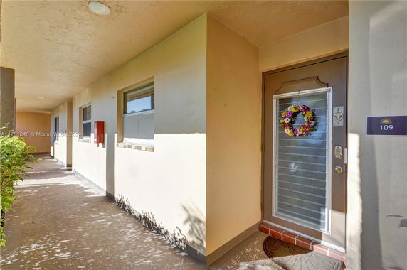 Front view of a building corridor with a decorative door.