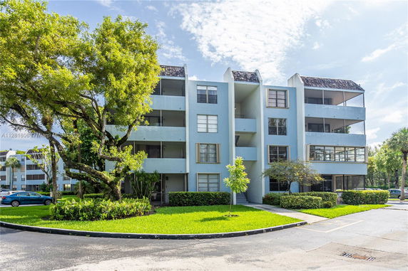 Front view of a multi-story residential building with balconies.