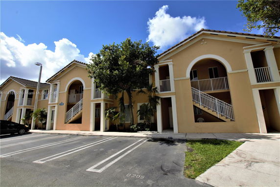 Front view of a two-story building with stairs and balconies.