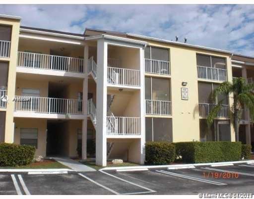 Front view of a multi-story apartment building with balconies.