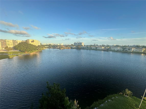 Wide angle view of a lake surrounded by residential buildings.
