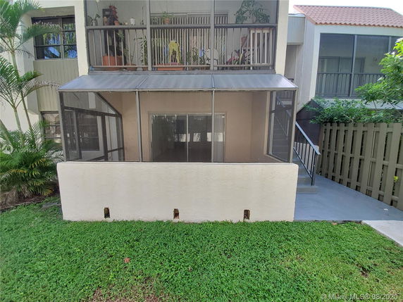 Front view of a building with a patio and staircase.