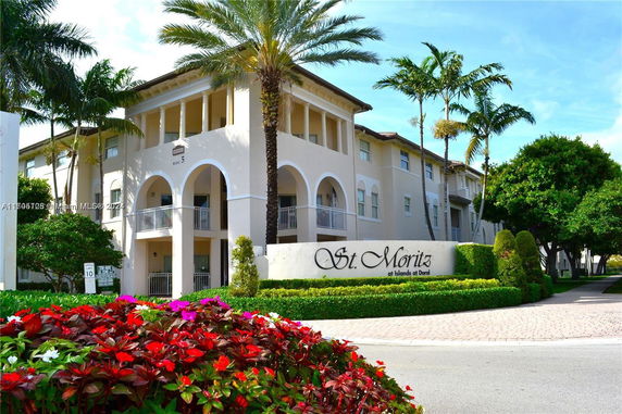 Front view of a multi-story building with arches and balconies.
