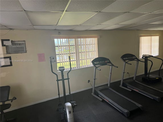 Indoor gym area with exercise equipment including treadmills and an elliptical machine.