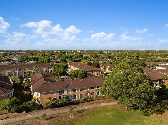 Panoramic view of residential buildings with brown roofs and surrounding greenery.