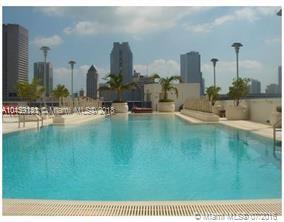 Rooftop pool with city skyline in the background.