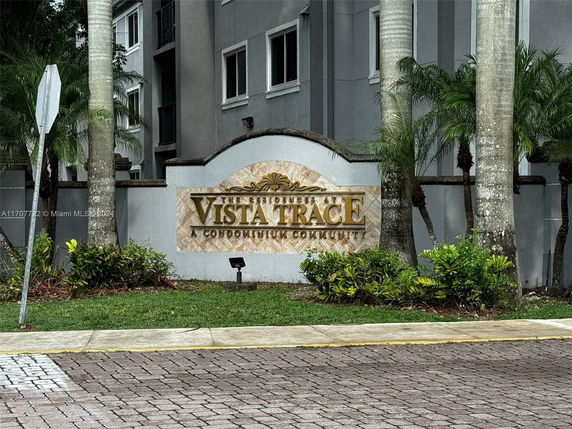 Front view of a condominium building with a sign reading 'Vista Trace'.