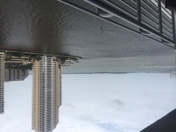 View of tall residential buildings near a waterfront.