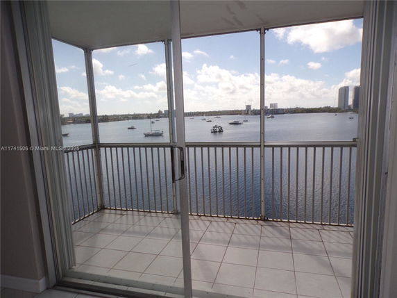 Panoramic view from a balcony overlooking a body of water with boats.