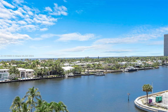 Panoramic view of a riverside area with houses and a waterway.