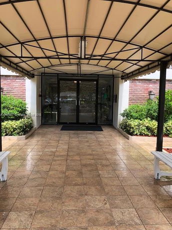 Entrance view of a building with a glass door and canopy.