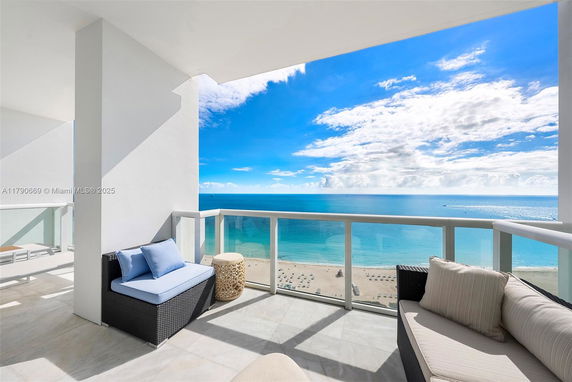 Balcony view overlooking the ocean and beach.