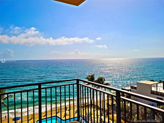 View of the ocean from a balcony with railing.