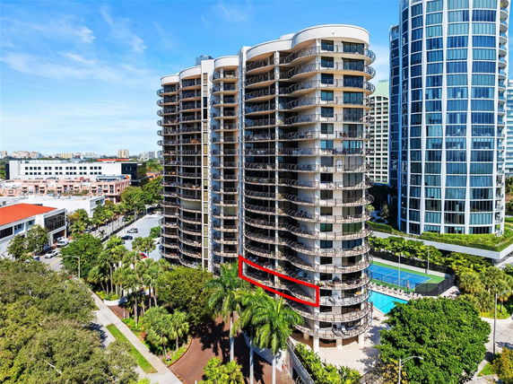 Front view of a high-rise residential building with curved balconies.
