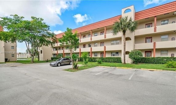 Front view of a multi-story building with balconies.