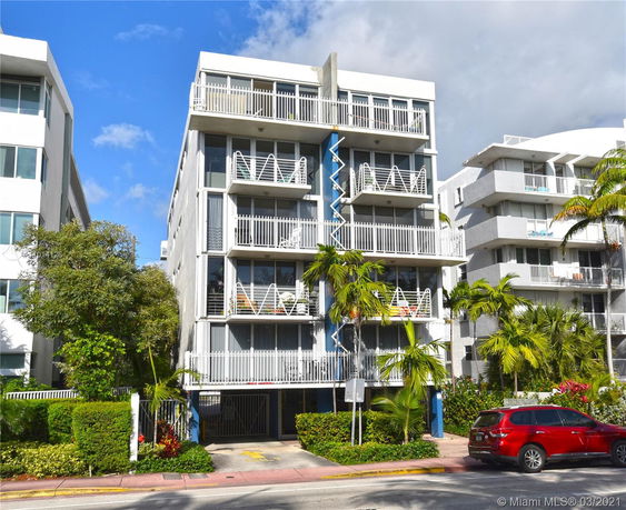 Front view of a multi-story building with balconies.
