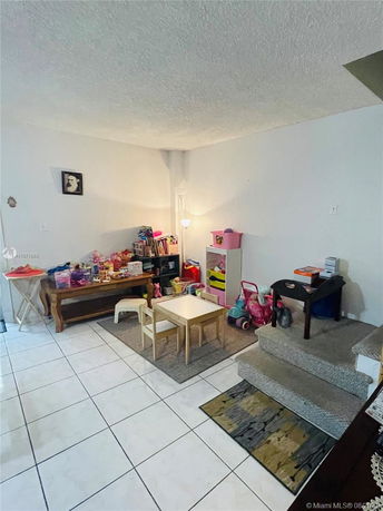 Indoor play area with small furniture and toys.