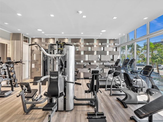 Indoor gym area equipped with exercise machines and weight racks.