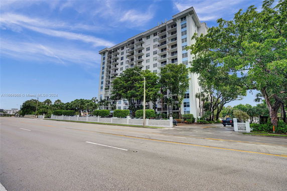 Front view of a multi-story residential building with balconies.