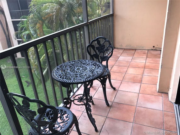 View from a balcony with wrought iron table and chairs.