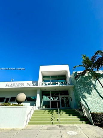 Front view of a building with the signage 'Flamingo Park Tennis Center'.