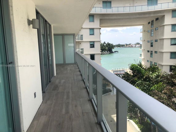 Balcony view overlooking surrounding buildings and water.