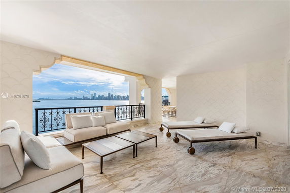 Open terrace with lounge chairs offering a view of the water and city skyline.