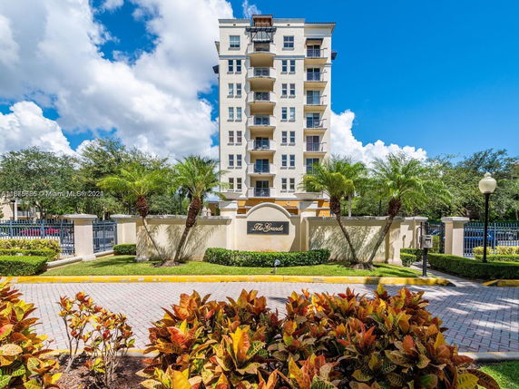 Front view of a multi-story residential building with balconies.