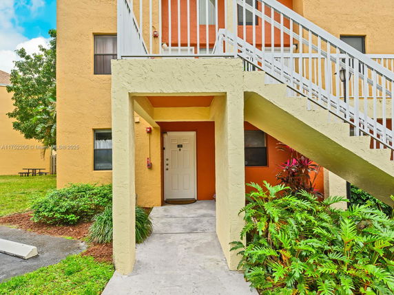 Front view of a two-story building with external staircase.