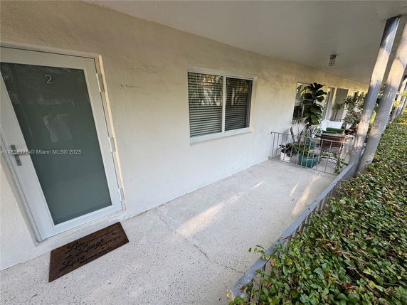 Exterior view of a building entryway with a door and window.