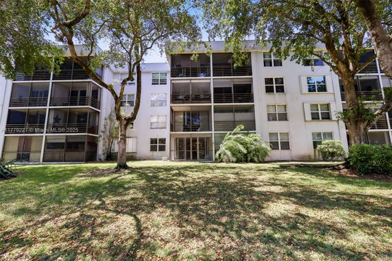 Front view of a multi-story building with balconies.