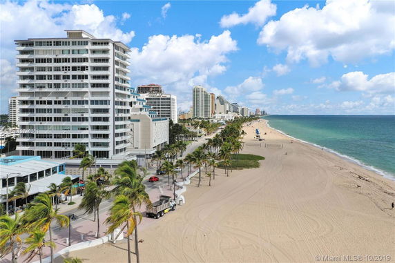 View of beachfront with tall buildings lining the shore.