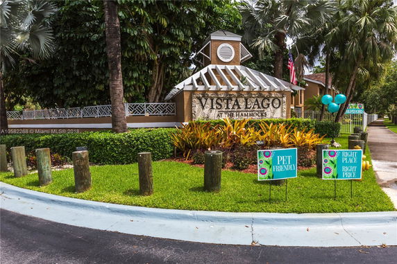 Front view of a building entrance with a sign reading 'Vista Lago at The Hammocks'.